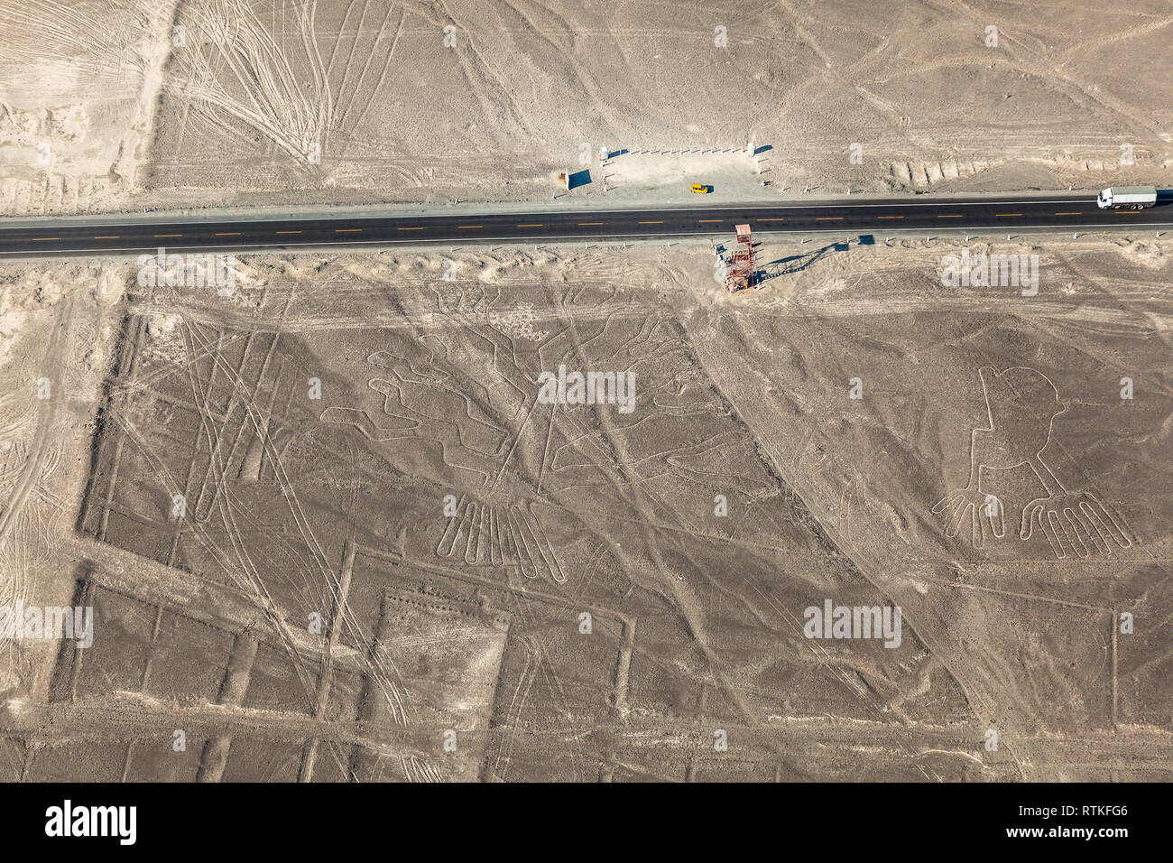 Aerial view of the Nazca lines, hands and tree, next to the road and observation tower, Peru Stock Photo