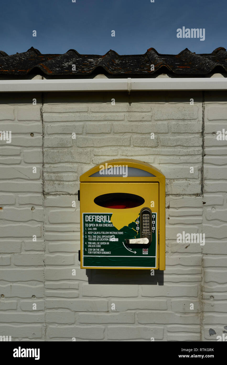 Manual external defibrillator on outside wall for public use, Canterbury area, England Stock Photo