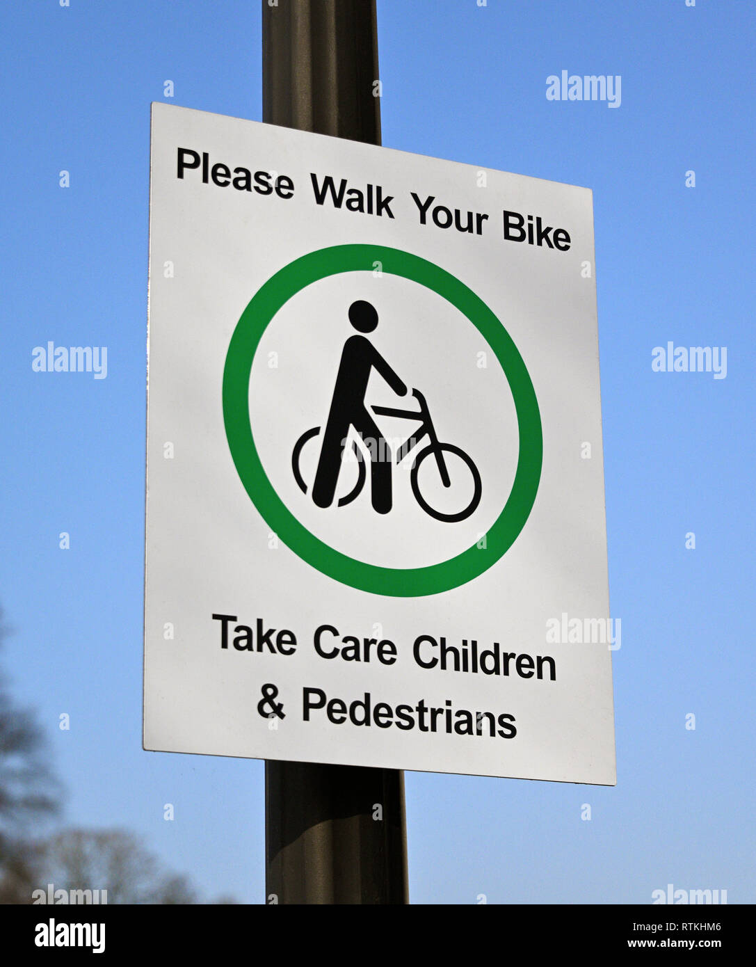Safety Sign. 'Please Walk Your Bike. Take Care Children & Pedestrians'. K Village, Kendal, Cumbria, England, United Kingdom, Europe. Stock Photo
