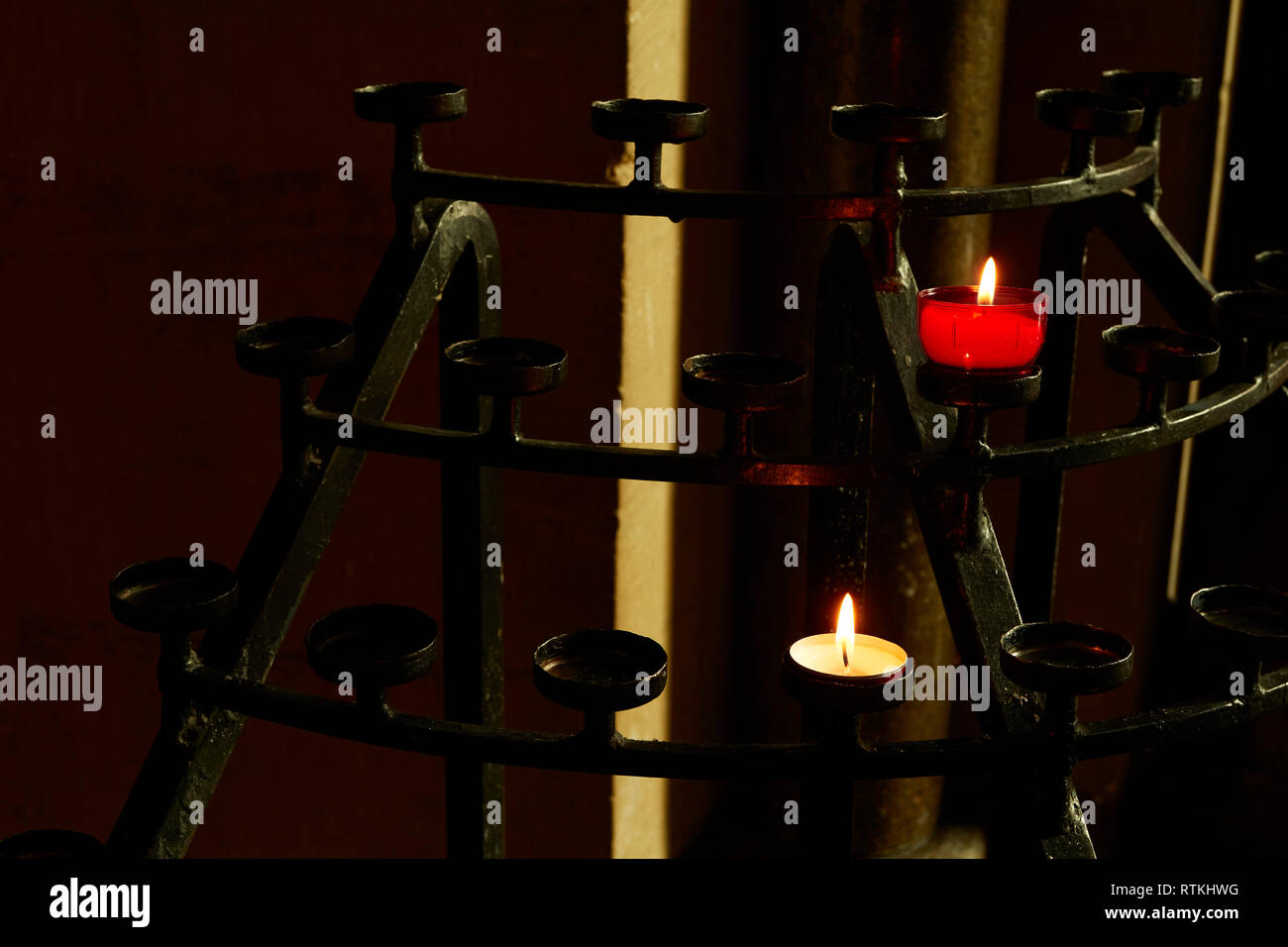 White votive candle on stand in church, Kent, England, United Kingdom