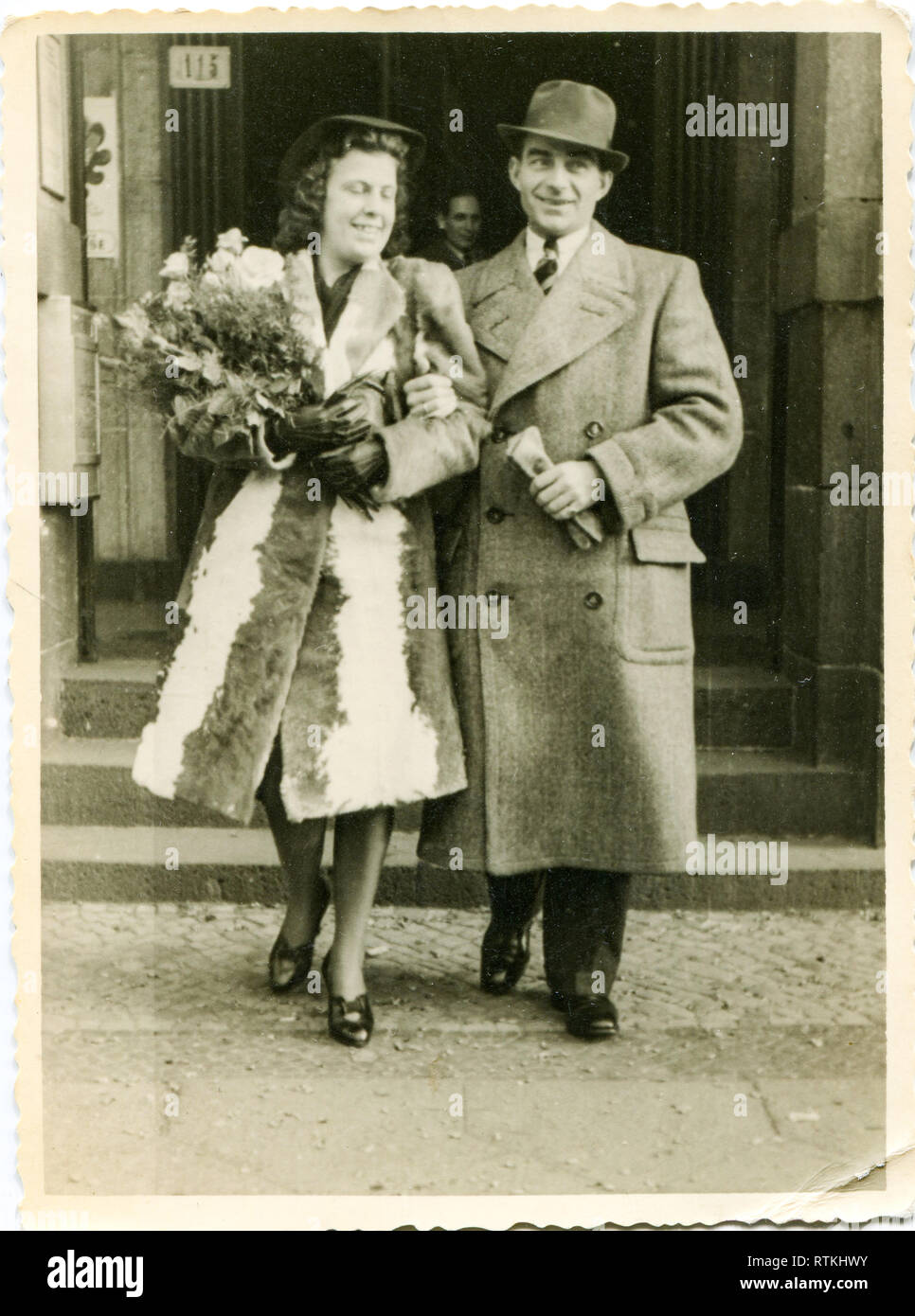 Germany. 1940s . Elegant and happy spouses. A woman in a beautiful fur coat, a man in a fashionable coat. Stock Photo