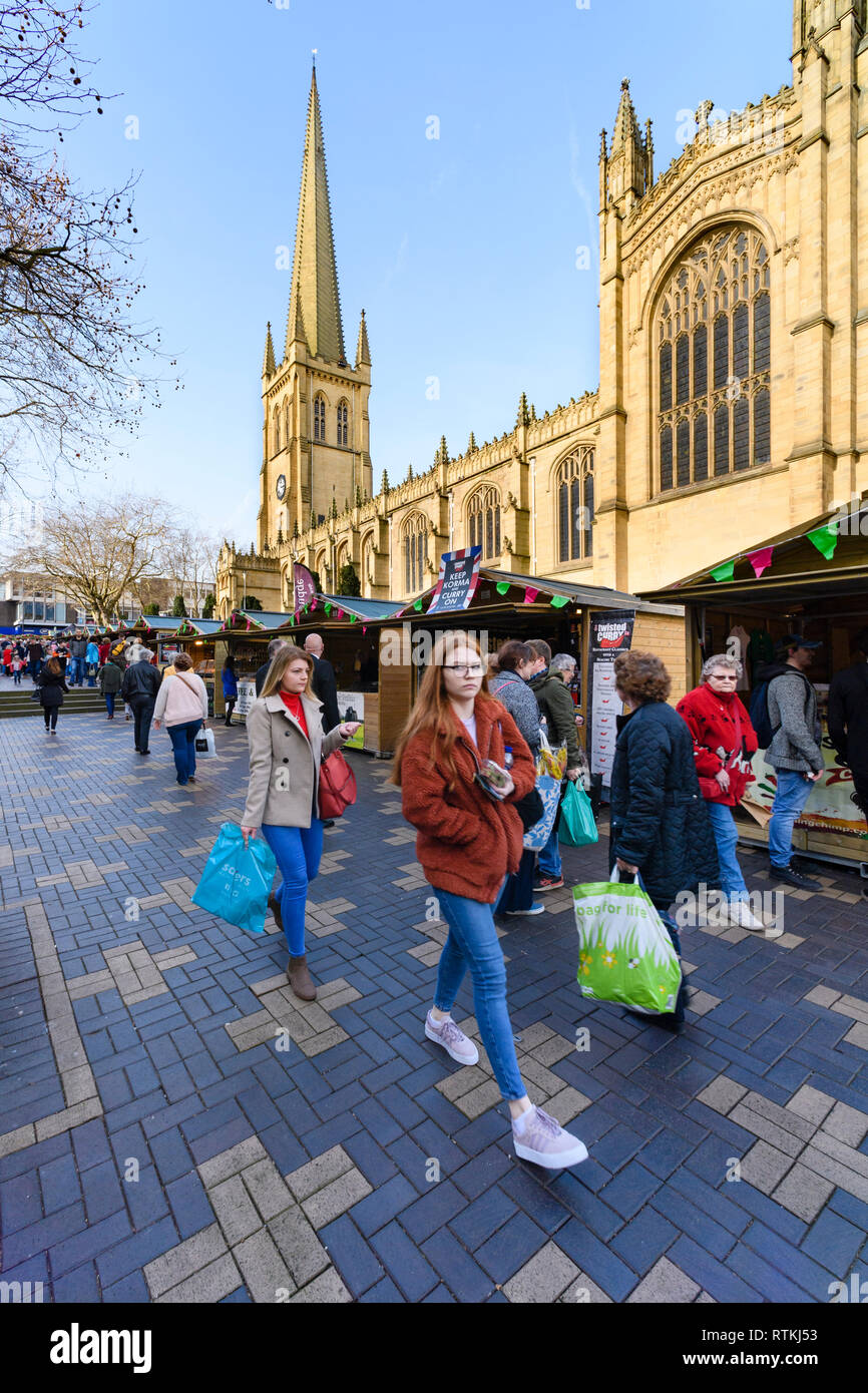 People shopping at Wakefield Food, Drink & Rhubarb Festival 2019, visiting market trade stalls in cathedral precinct - West Yorkshire, England, UK. Stock Photo