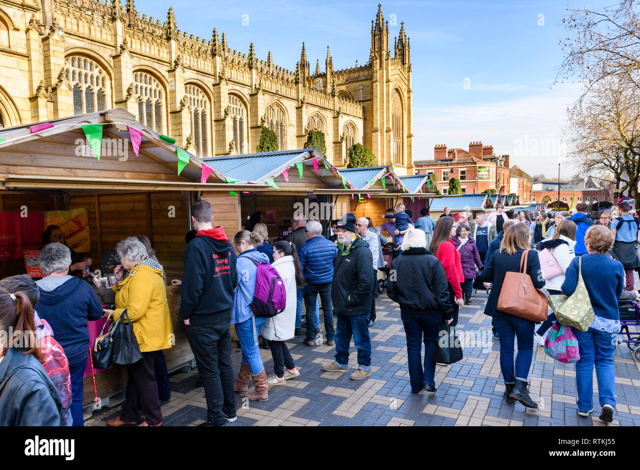 People shopping at busy Wakefield Food, Drink & Rhubarb Festival 2019, visiting market trade stalls & cathedral precinct - West Yorkshire, England, UK Stock Photo