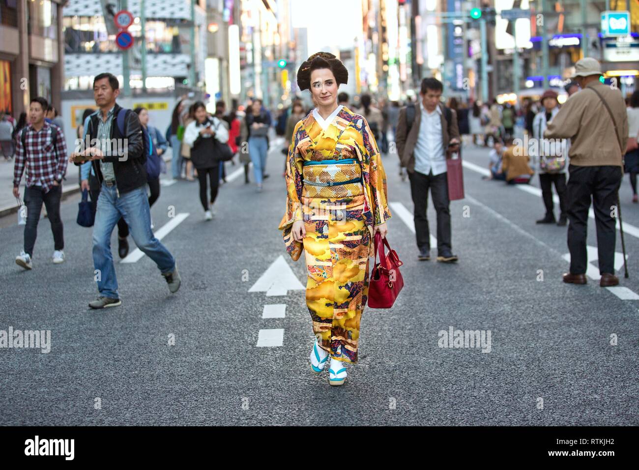 beautiful foreign women wearing Japanese traditional costume kimono in the streets of Tokyo,japan,multi ethnic japan,Japanese street,Tokyo street Stock Photo