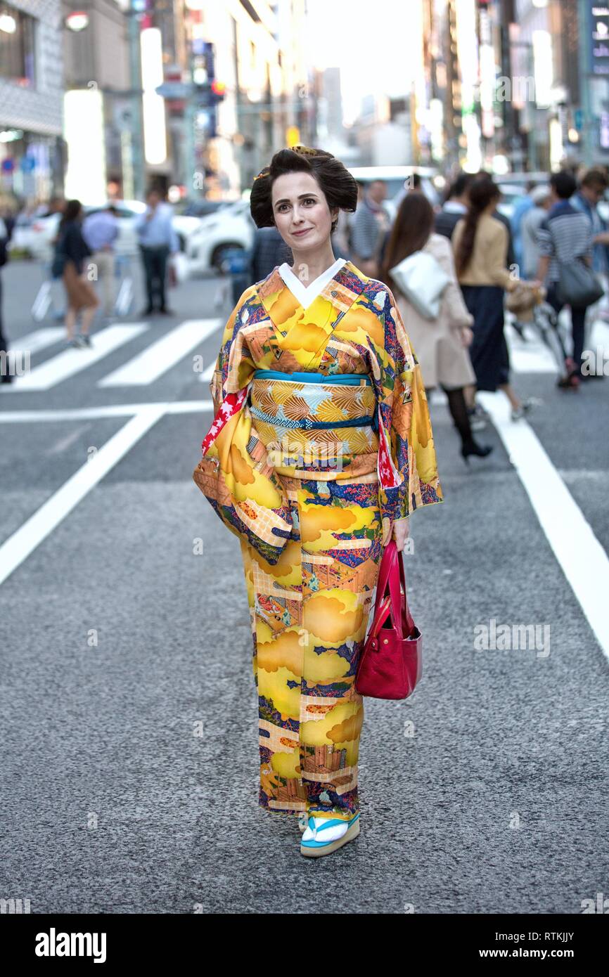 beautiful foreign women wearing Japanese traditional costume kimono in the streets of Tokyo,japan,multi ethnic japan,Japanese street,Tokyo street Stock Photo