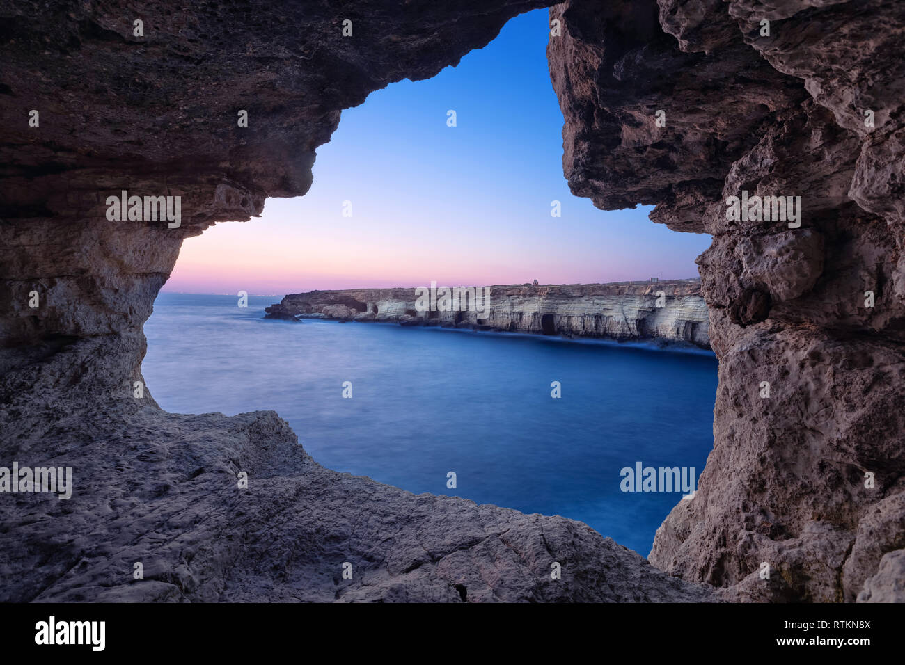 Sea cave at dusk on Cape Greco near Ayia Napa, Cyprus (HDR image) Stock Photo