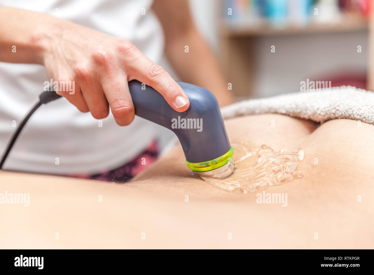 physiotherapist doing electromagnetic therapy to a patient Stock Photo
