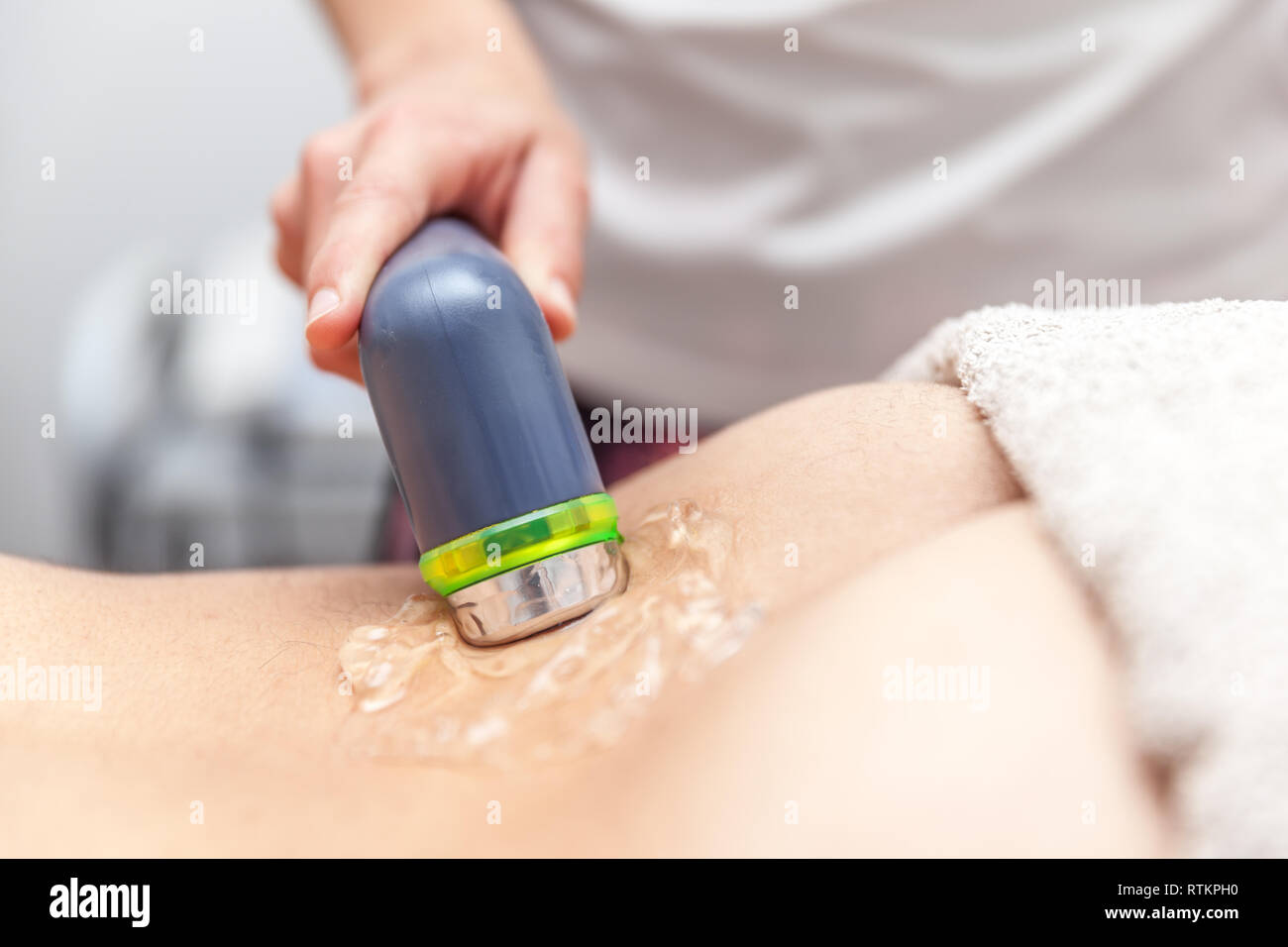 physiotherapist doing electromagnetic therapy to a patient Stock Photo