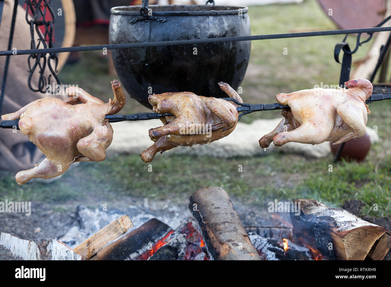 Whole chicken being roasted on an open fire Stock Photo Alamy