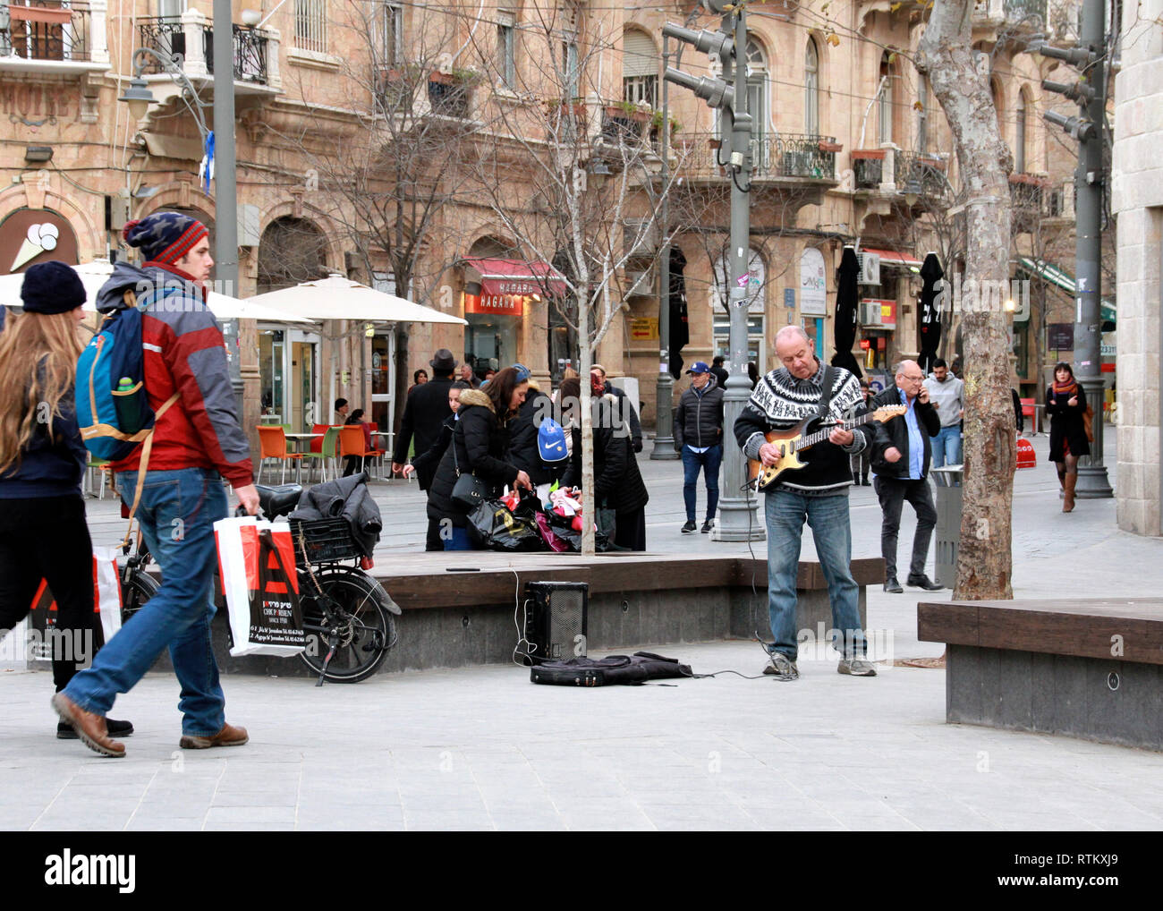 A street musician performs among many pedestrians on Ben Yehudah in Jerusalem. Stock Photo