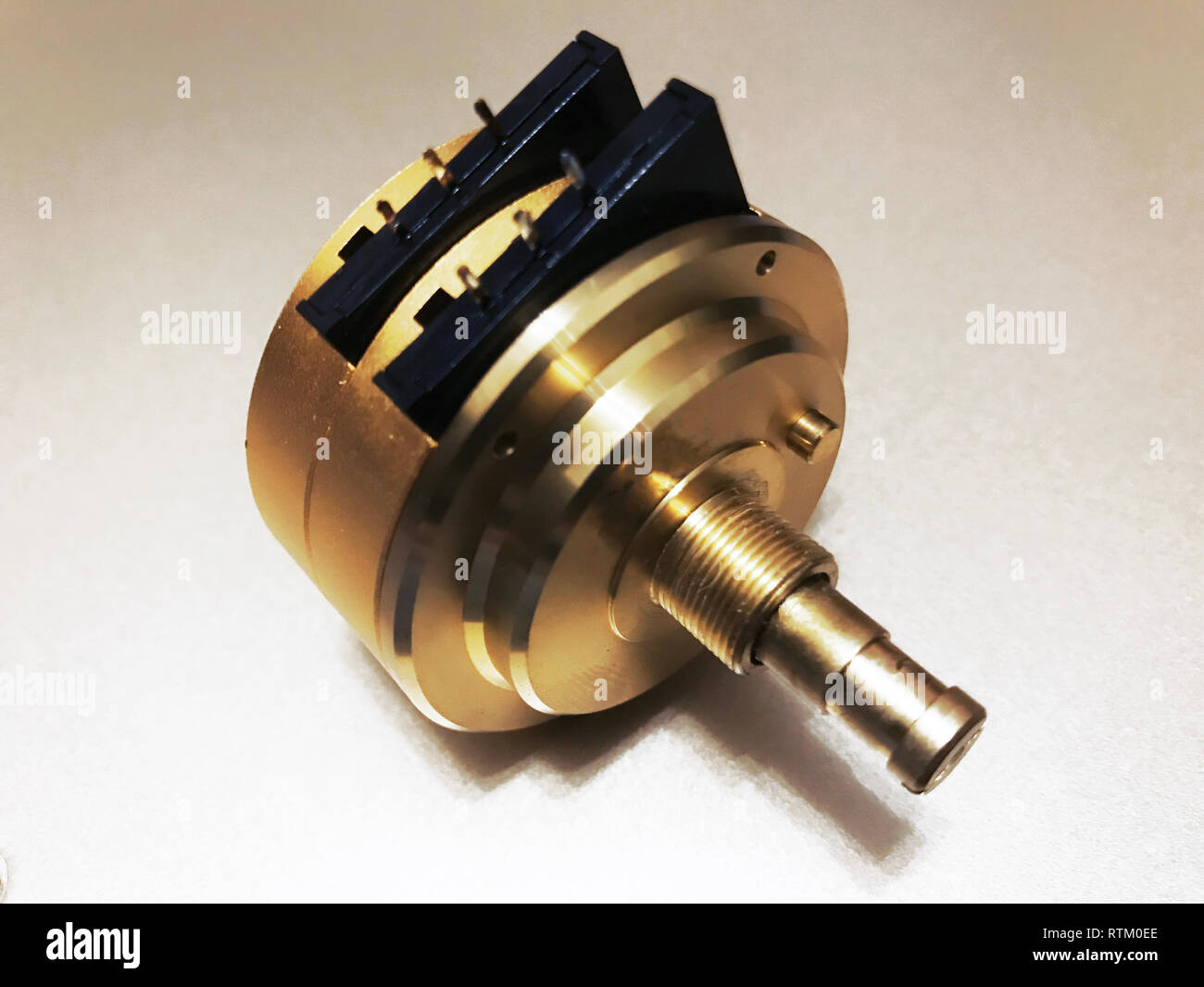 Big golden Volume control Resistor lay on white background Stock Photo