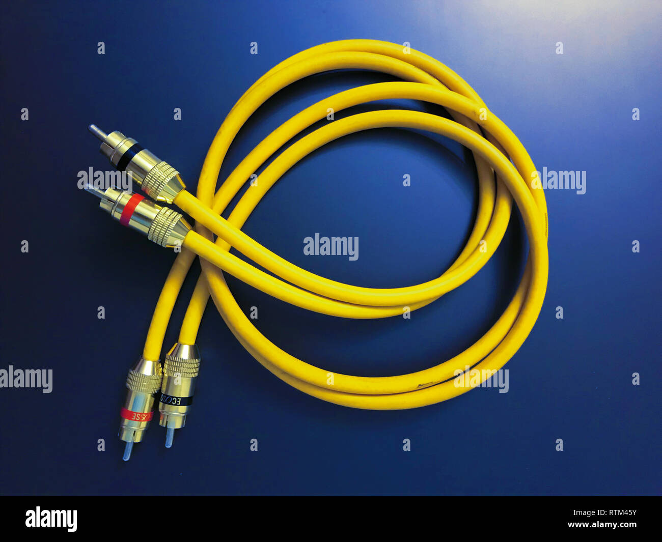 stereo audio extension yellow cable isolated on blue background Stock Photo