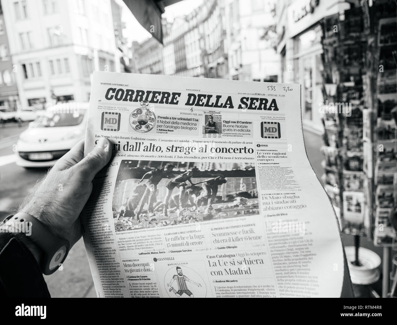 PARIS, FRANCE - OCT 3, 2017: Man buying Corriere della Sera newspaper with  socking title and photo