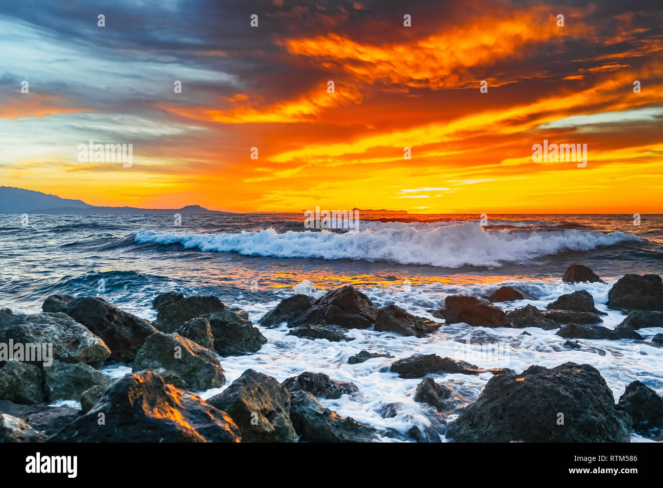 Bright sunset under the storm sea with waves splashes Stock Photo - Alamy