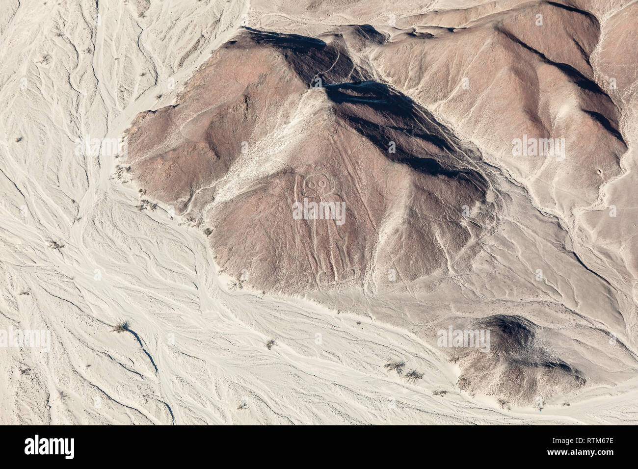 Aerial view of the relief of the desert and the lines of Nazca, the astronaut, Peru Stock Photo