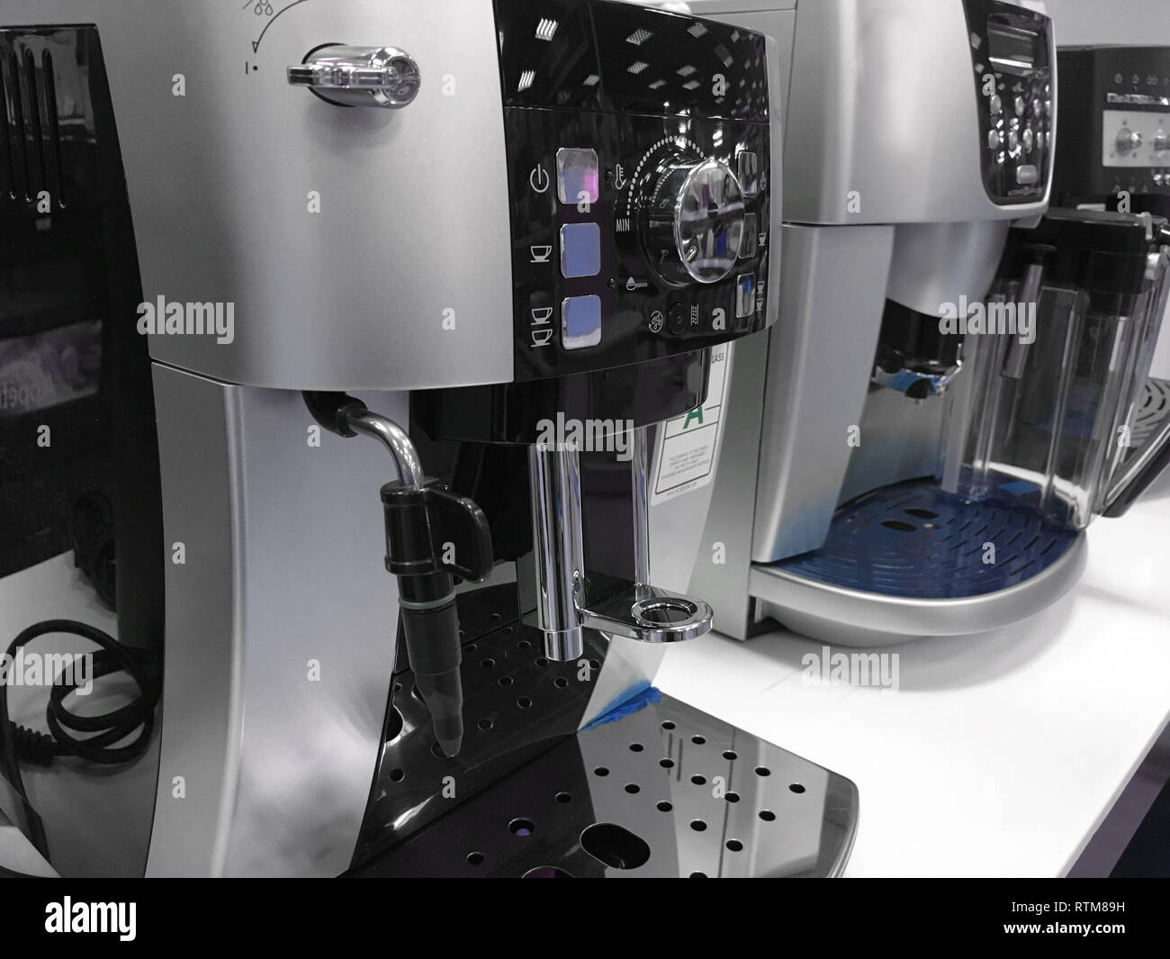 automatic coffee machines at exhibition on white kitchen background Stock Photo