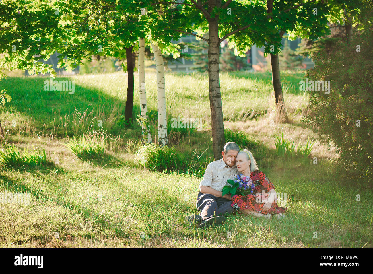 Happy and very old people sitting in the park. Stock Photo