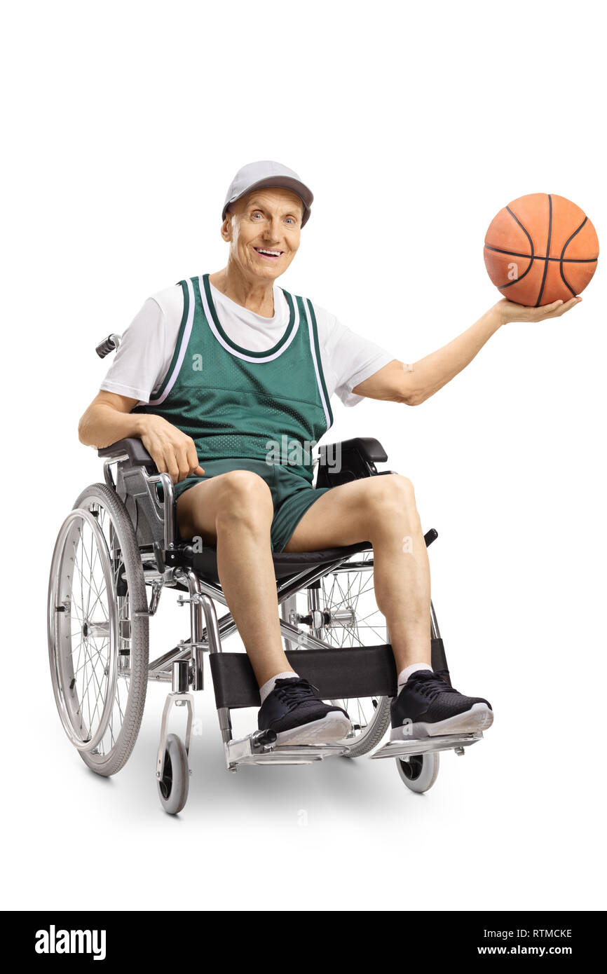 Senior disabled man in a wheelchair holding a basketball and smiling at the camera isolated on white background Stock Photo