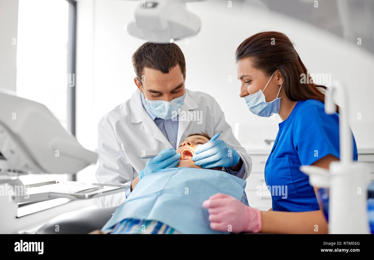 dentist checking for kid teeth at dental clinic Stock Photo Alamy