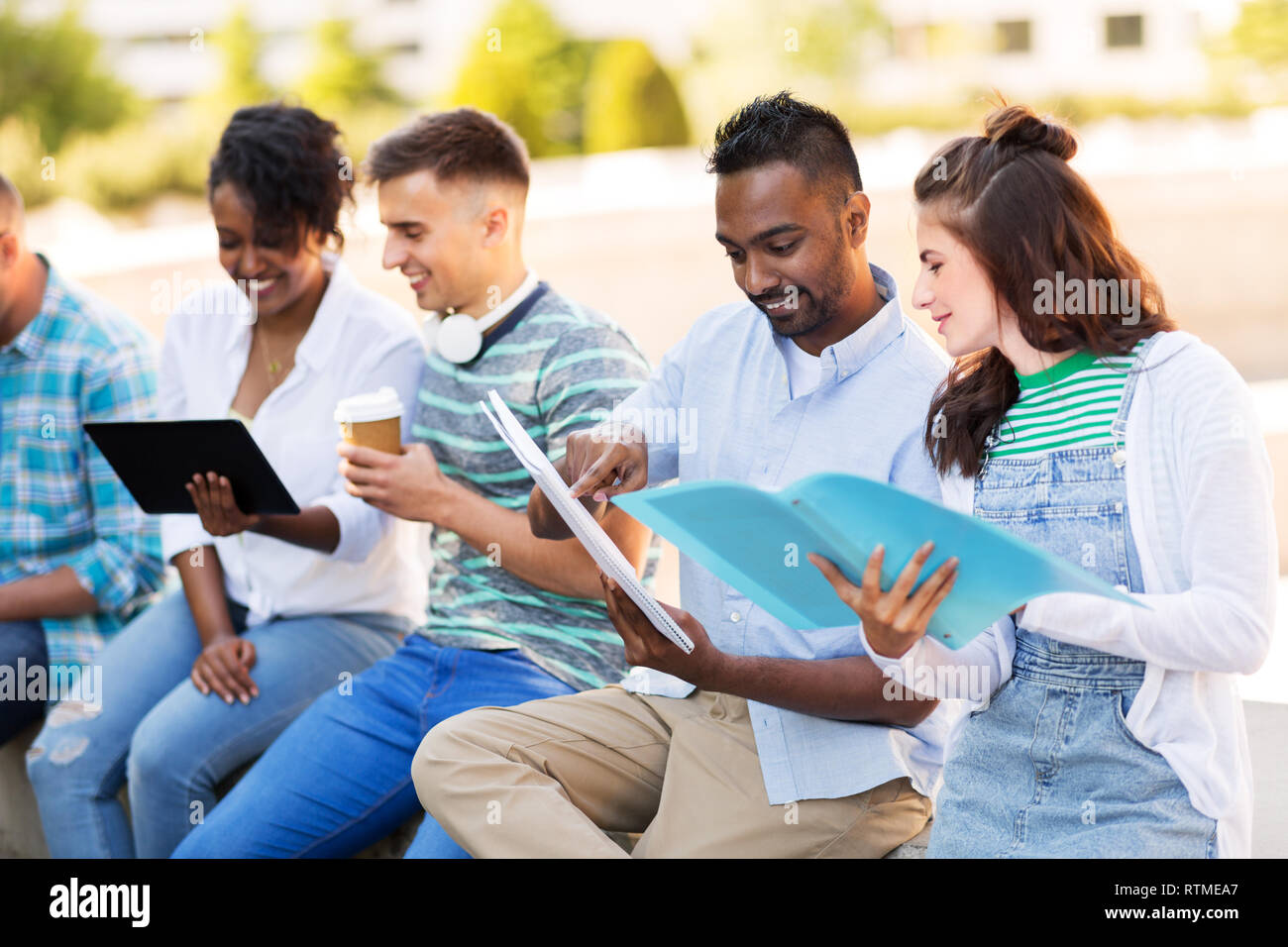 international students with notebooks outdoors Stock Photo