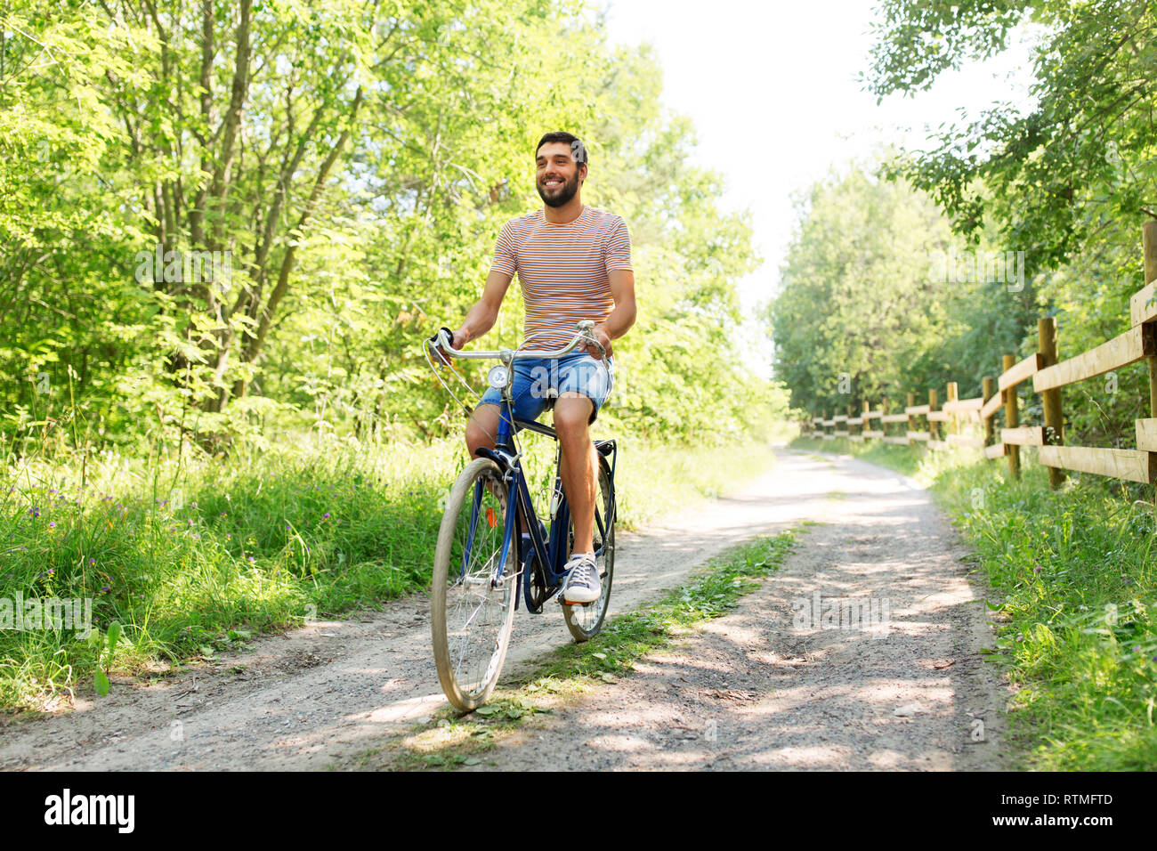 man riding fixie bicycle at summer park Stock Photo