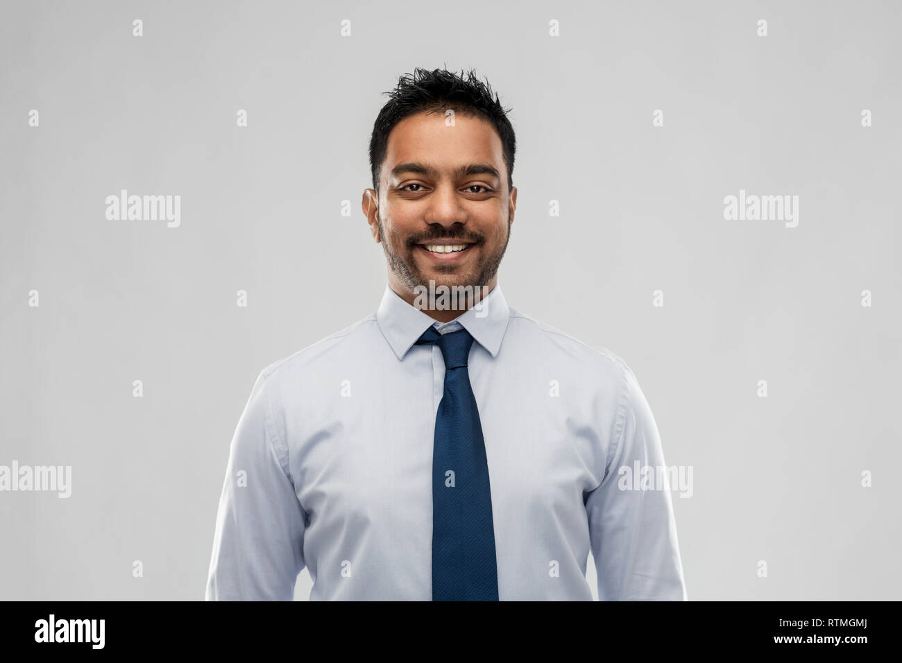 indian businessman in shirt with tie over grey Stock Photo