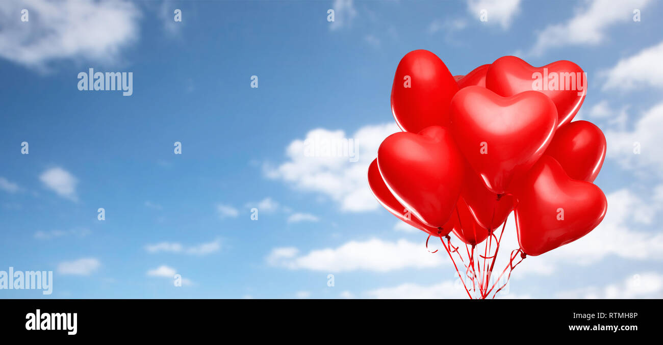red heart shaped helium balloons on white Stock Photo
