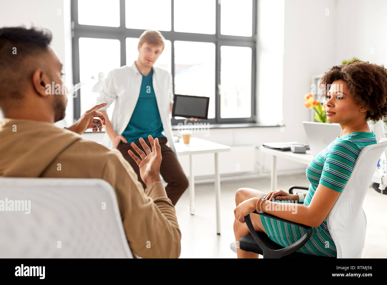 man showing tablet pc to creative team at office Stock Photo