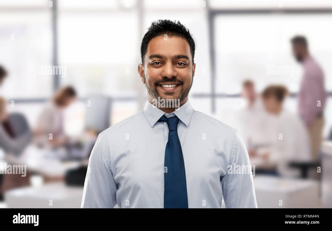 indian businessman in shirt with tie over office Stock Photo