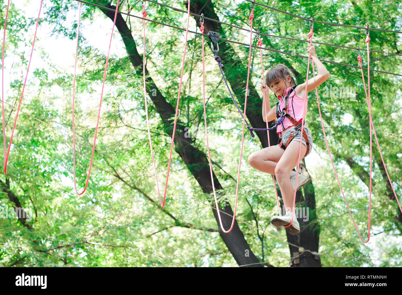 adventure climbing high wire park hiking in the rope park girl in