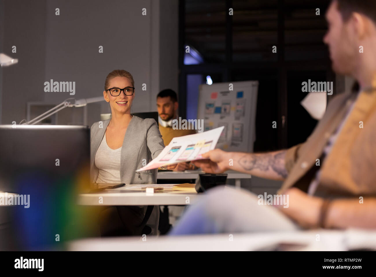designers or software developers at night office Stock Photo