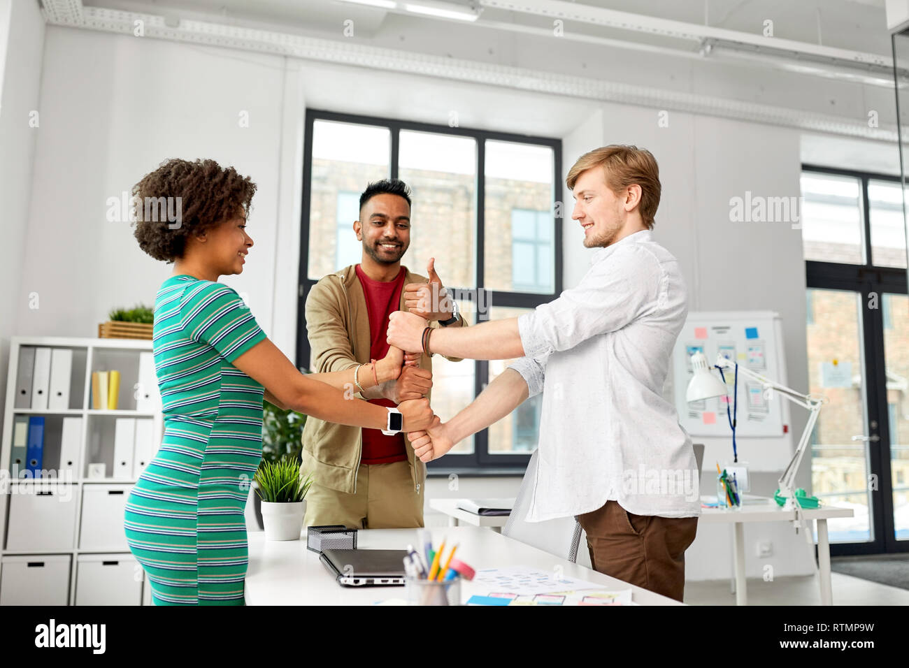 happy creative team making high five at office Stock Photo