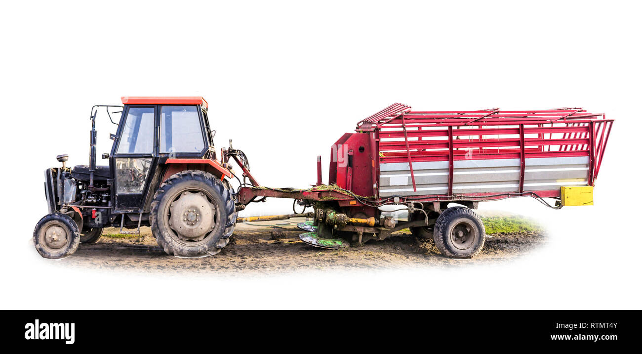 Tractor with a  trailer. The trailer is a rotary mower for various herbs and a container for mowed plants. Isolated photo.Equipment for a dairy farm. Stock Photo