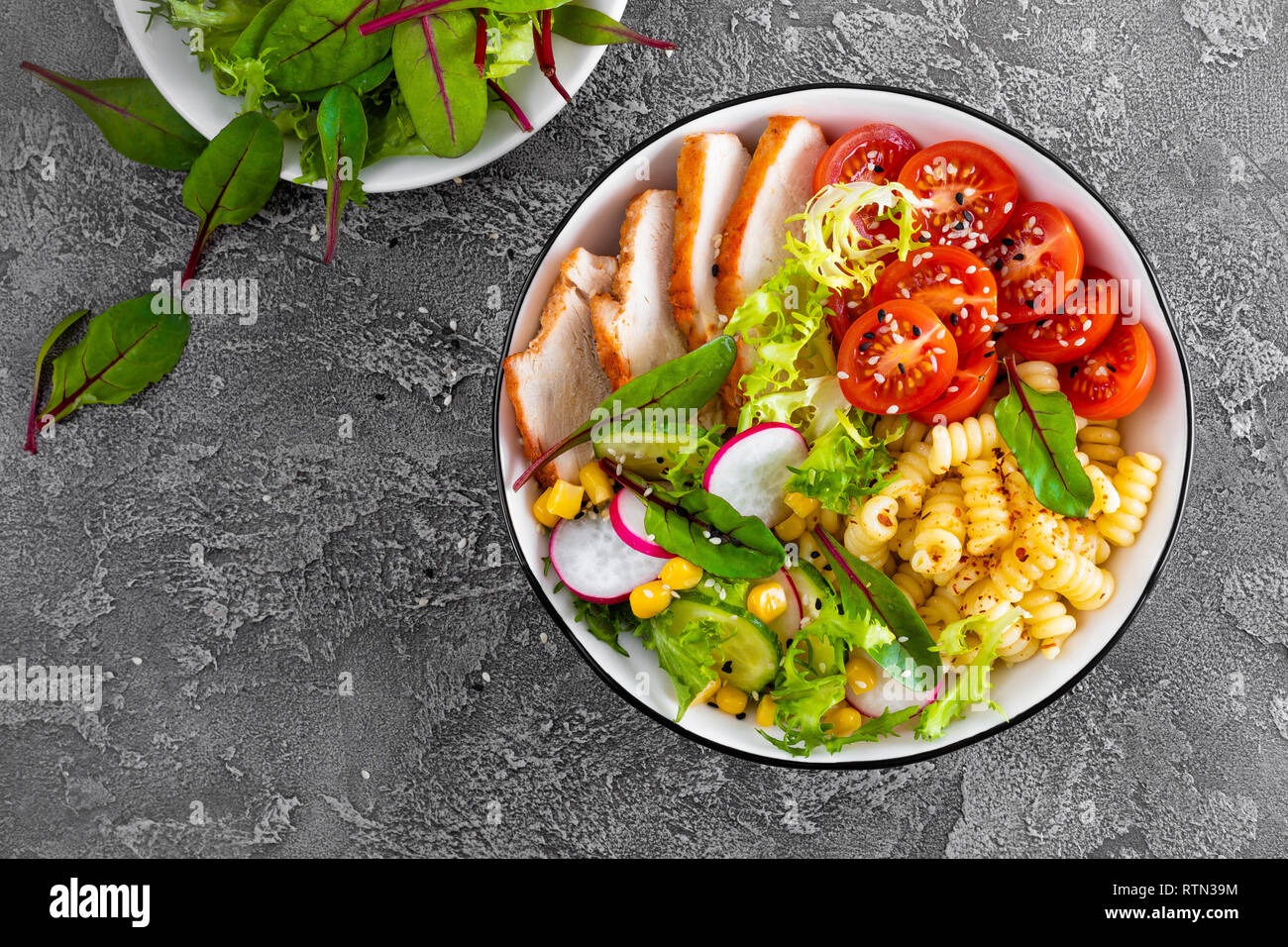 Grilled Chicken Meat With Fresh Vegetable Salad Of Tomato Cucumber Radish Lettuce Chard Leaves Corn And Pasta Healthy Lunch Menu Top View Stock Photo Alamy