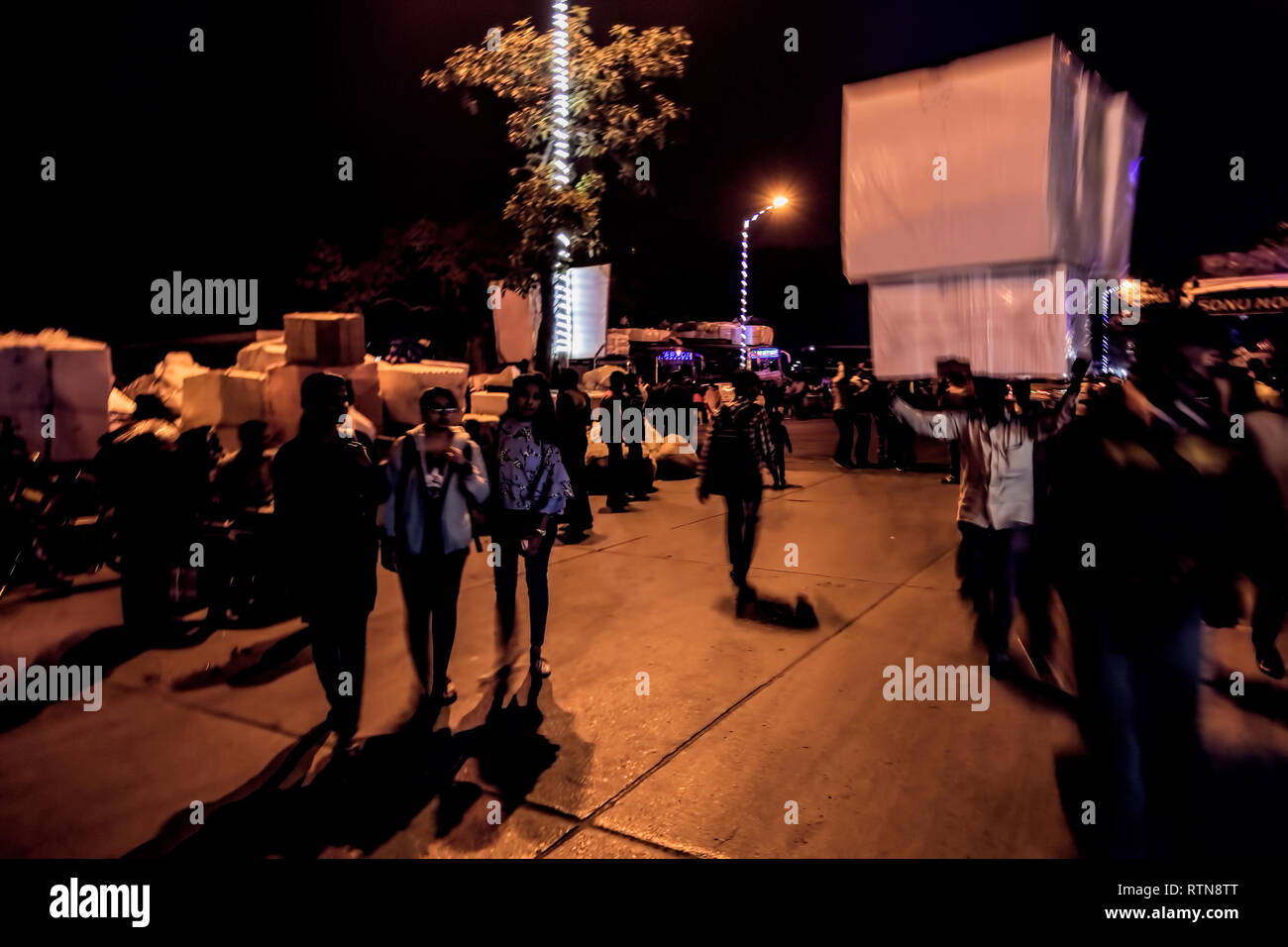 Gangasagar mela,pilgrims transit camp,Busy street crossing,at,Dusk,Babught, Kolkata,India. Stock Photo