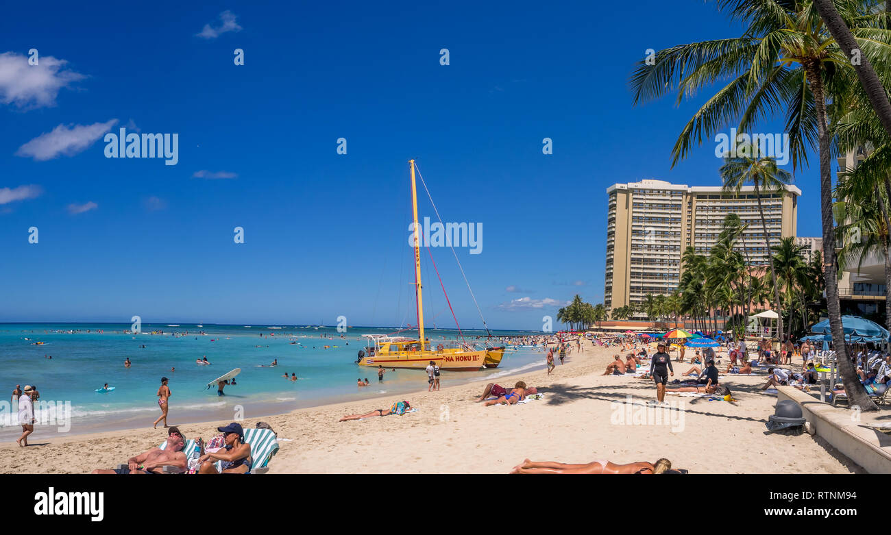 A catamaran waiting for tourists at Waikiki Beach on August 3, 2016 in Honolulu. Catamarans are a popular tourist activity at Waikiki Beach and offers Stock Photo