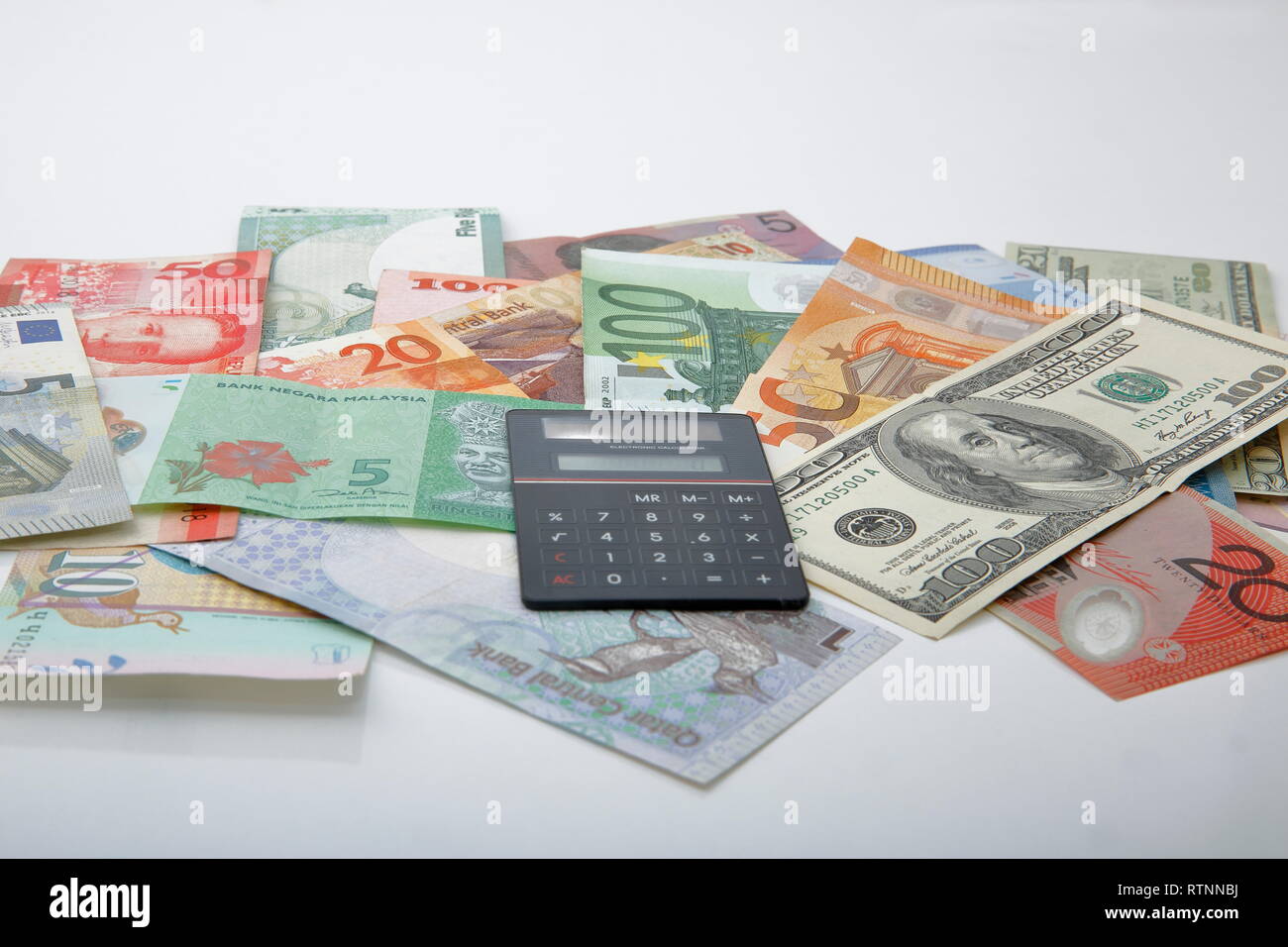 A composition with various country banknotes on a white background. Stock Photo
