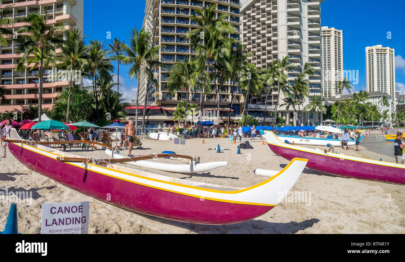 Hawaiian canoes waiting for tourists at Waikiki Beach on August 4, 2016 in Honolulu. Canoes are