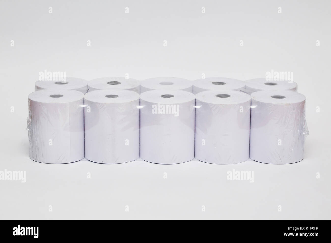 Roll of cash register tape isolated on soft gray background.High