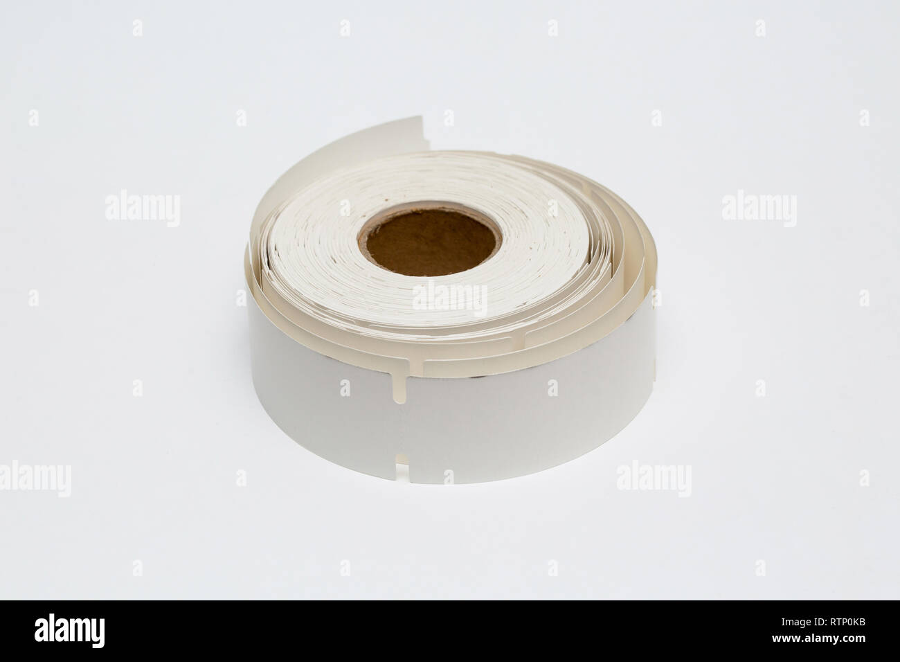 Roll of cash register tape isolated on soft gray background.High