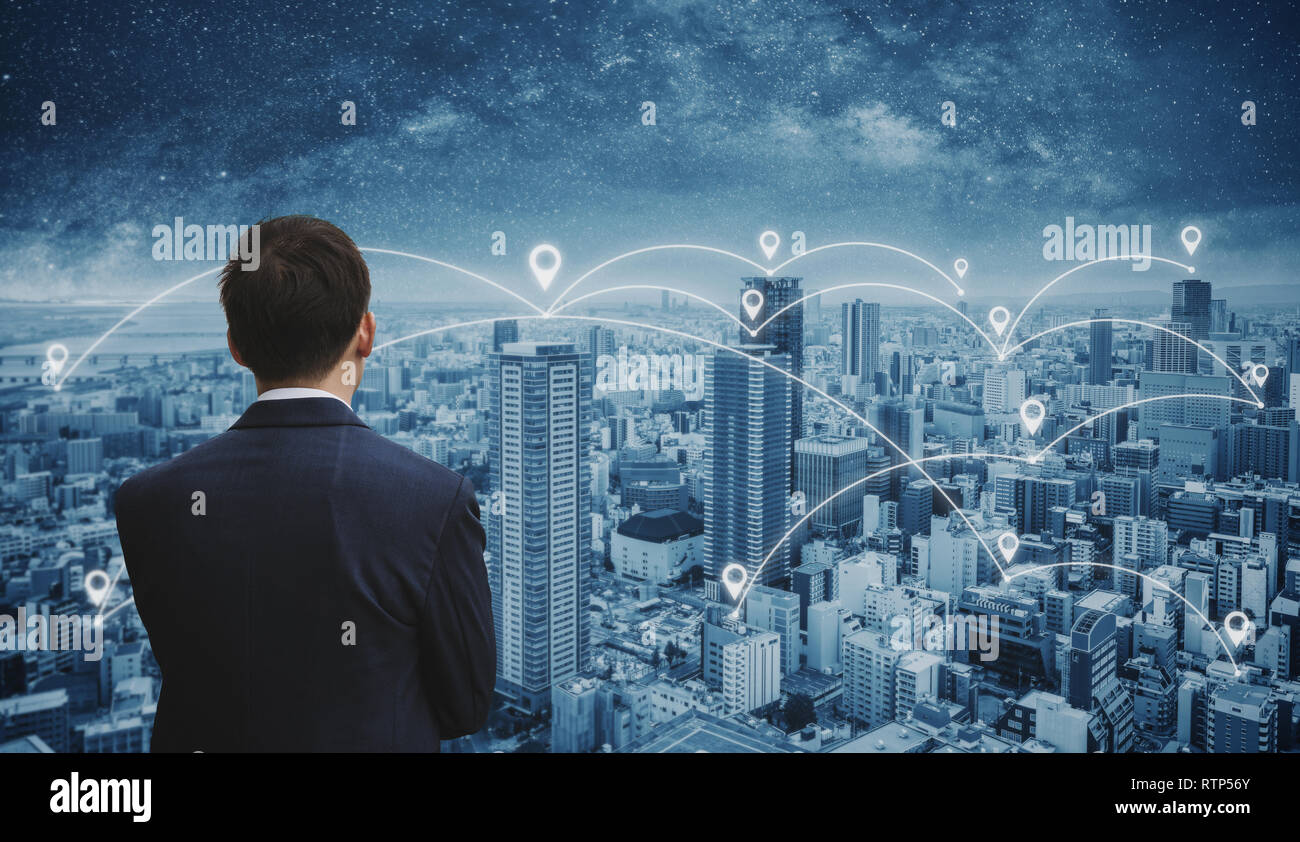 Business network technology, logistics and blockchain business. Businessman in blue suit with japan cityscape Stock Photo