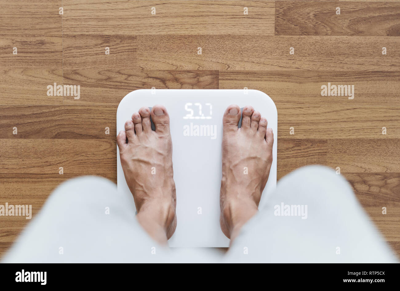 Top view, a man using body scale checking body weight, dieting and lose weight concept Stock Photo