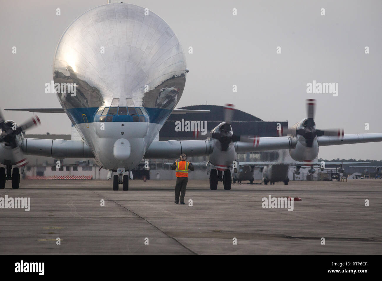 The National Aeronautics and Space Administration’s (NASA) B-377-SG/SGT Super Guppy Turbine cargo aircraft is taxied across the flight line at Marine Corps Air Station Cherry Point, North Carolina, Feb. 28, 2019. The Super Guppy is used for hauling outsize cargo components and is currently transporting one of NASA’s space capsules to a separate location for testing. (U.S. Marine Corps photo by Cpl. Micha R. Pierce) Stock Photo