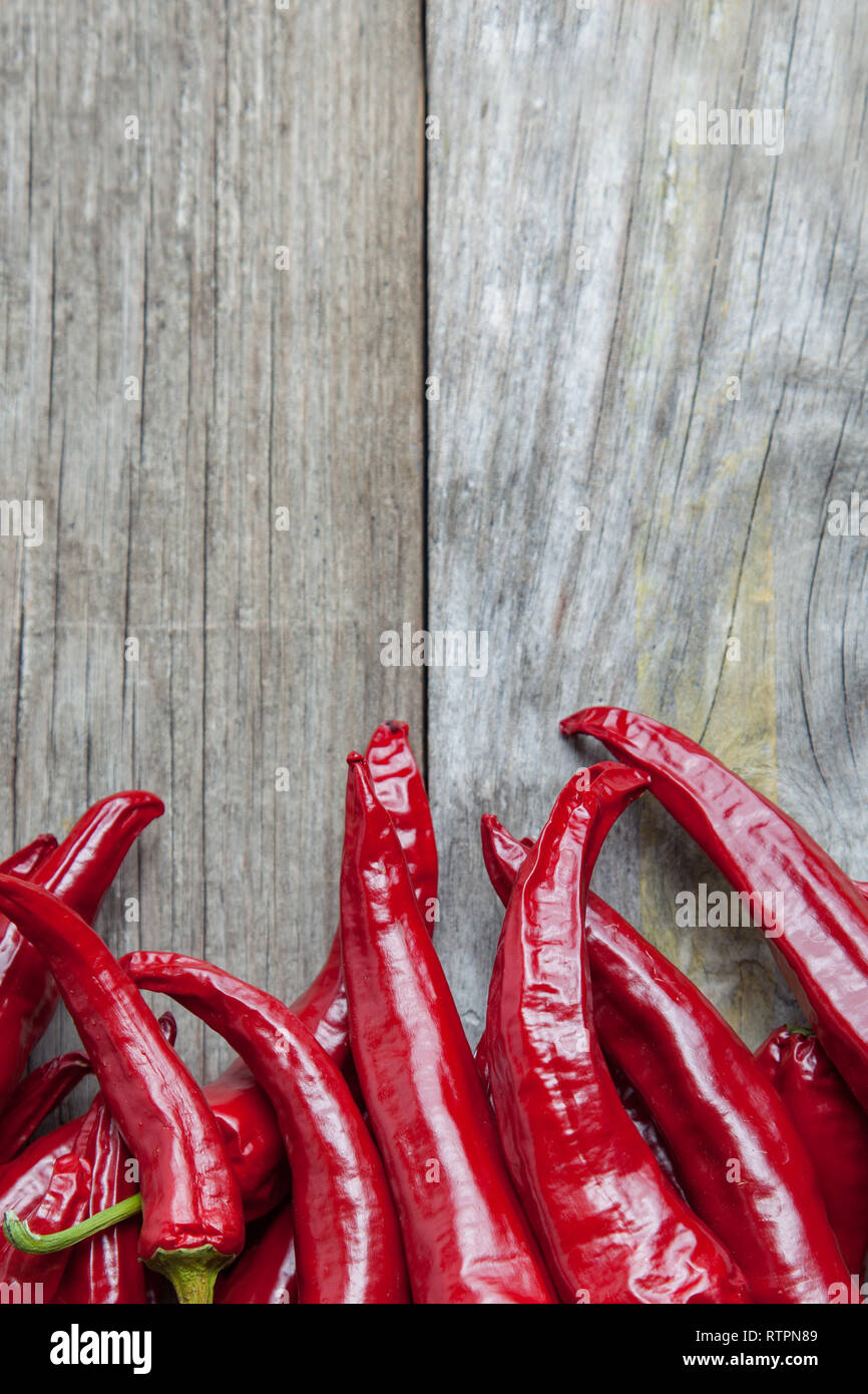 Red hot chili peppers on the wooden desk Stock Photo - Alamy