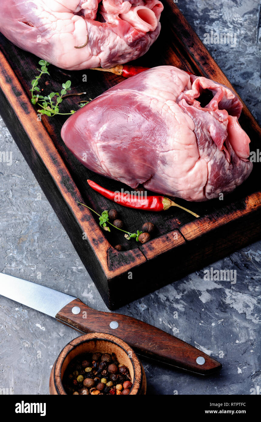 Whole pork heart on a chopping board Stock Photo Alamy