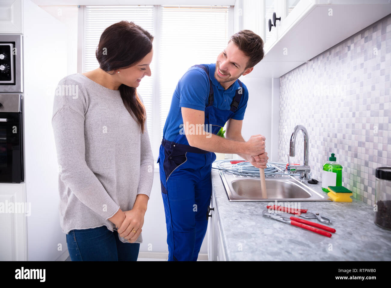 Overflowing Kitchen Sink, Clogged Drain. Hand Holding Plunger. Stock Photo  - Image of homemaker, home: 208234932