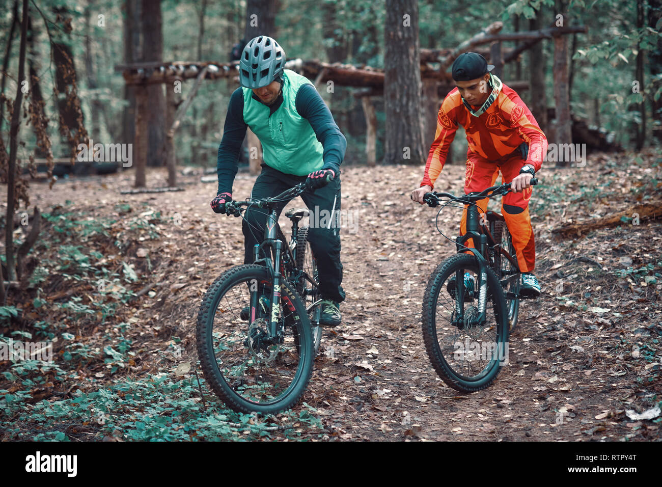 Moscow, Russia - Nov, 2018: MTB teacher helping rider learn to ride  bicycle. Teaching a rider to ride a bike on a trail. Two friends have fun  in natu Stock Photo - Alamy