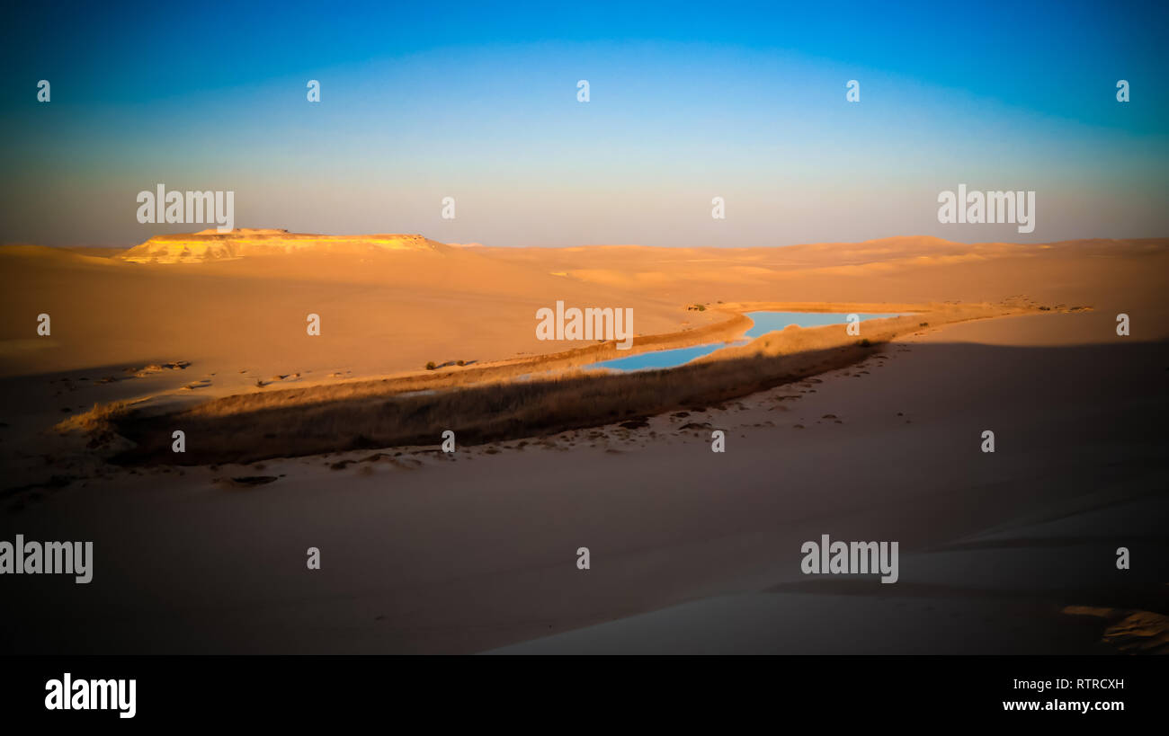 Aerial Panorama landscape at Great sand sea and lake near Siwa oasis at sunset, Egypt Stock Photo