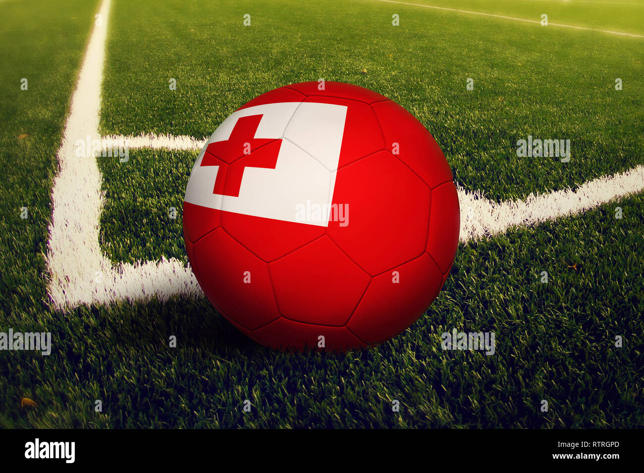 Tonga ball on corner kick position, soccer field background. National football theme on green grass. Stock Photo