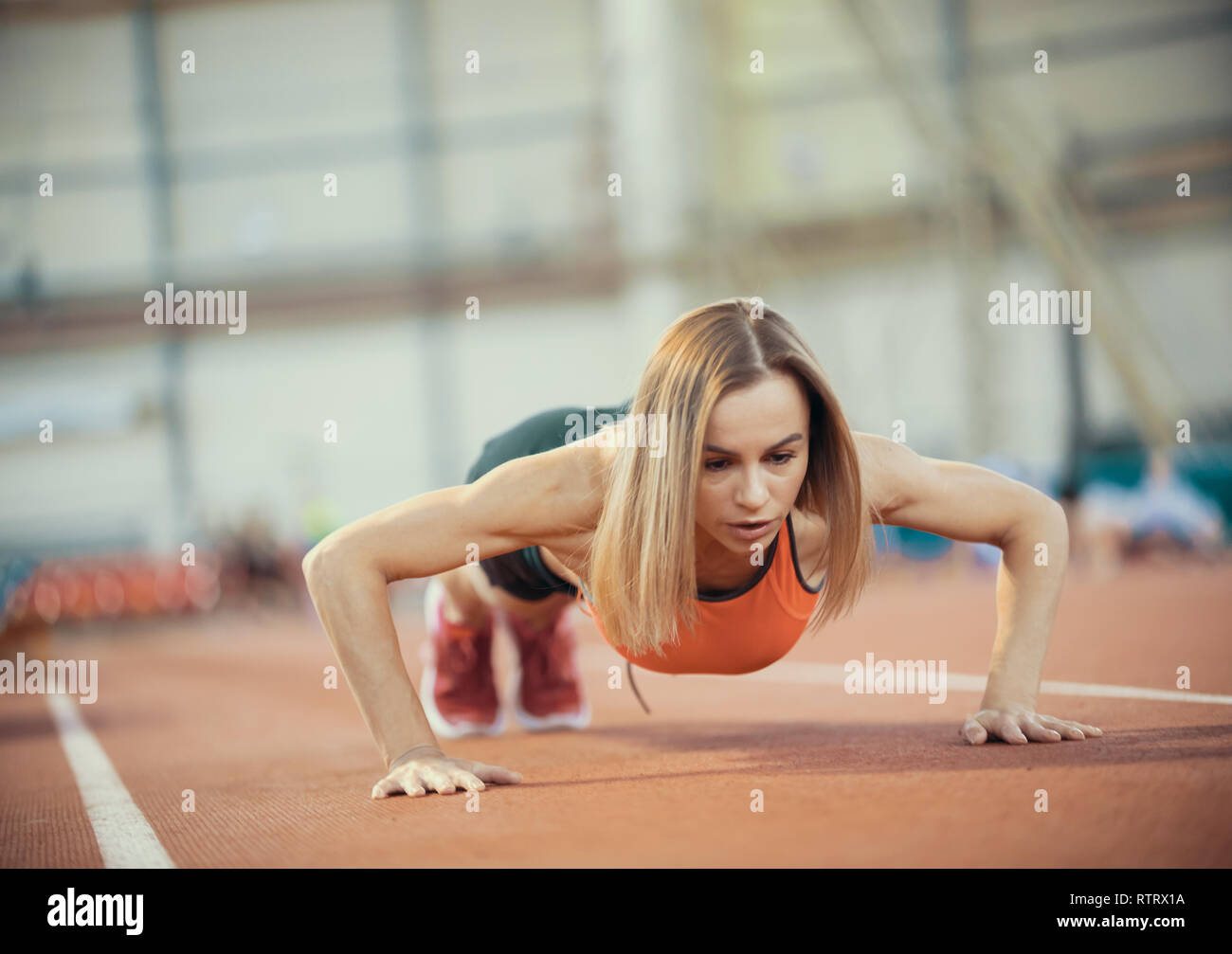 Young athletic woman doing exercises. Doing push ups Stock Photo